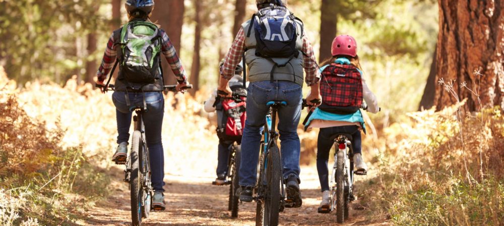 bigstock-Family-mountain-biking-on-fore-123820460-1-1920x1080